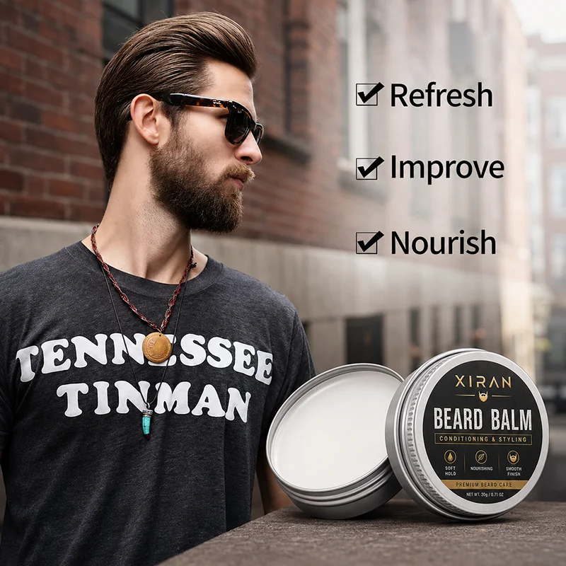 A tin of beard balm displayed on a ledge with text highlighting its benefits, next to a man wearing a Tennessee Tinman t-shirt.